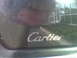 1993 Lincoln Town Car - Reflection of Cartier text on a car window, Supermotors.net logo visible at bottom right.