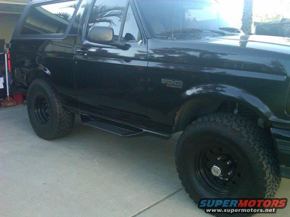 Black Ford Bronco, side view, showing running boards and off-road tires