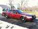 2005 Ford Crown Victoria - This red sedan, likely a 2005 Ford Crown Victoria, is shown in a 3/4 front view with a push bar installed.