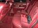 1993 Lincoln Town Car - The interior of a car features red velour and leather seats with red seatbelts.