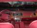 1993 Lincoln Town Car - The interior of a 1993 Lincoln Town Car features red upholstery and wood grain accents on the dashboard.