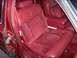 1993 Lincoln Town Car - The plush interior of a 1993 Lincoln Town Car features red velour seats with a diamond pattern and leather accents.