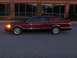 1993 Lincoln Town Car - Side profile of a maroon 1993 Lincoln Town Car parked in front of a brick building with large windows.