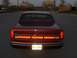 1993 Lincoln Town Car - Rear view of a red 1993 Lincoln Town Car, showing its distinctive taillight bar and license plate.