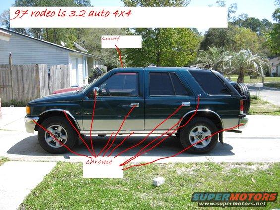 Side view of a dark green SUV with chrome trim and a spare tire on the back. Text overlay says '97 rodeo ls 3.2 auto 4x4'