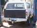 1989 Ford Bronco - Rear view of a white Ford Bronco, possibly from the late 1980s, with an aftermarket bumper and black tailgate insert.