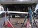 1989 Ford Bronco - Vehicle suspension work in progress, with a measuring tool positioned over the axle.