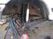 1989 Ford Bronco - The vehicle's front axle and suspension are disassembled, showing new shocks and springs being fitted.