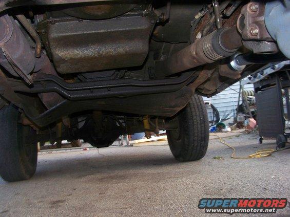Underside of a vehicle showing drivetrain components and rear axle