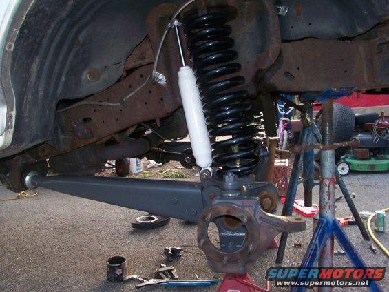 Front suspension assembly with new coil spring and shock absorber, part of an axle swap