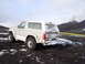 1992 Ford Bronco - A 1992 Ford Bronco sits in a snowy, volcanic landscape with a plume of smoke rising in the distance.