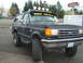 1989 Ford Bronco - The front of a Ford Crown Victoria is shown, its grille, headlights, and a license plate from Massachusetts.