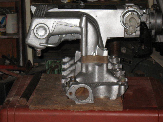 Silver intake manifold on wooden block