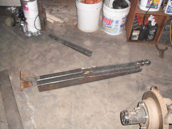 Welded steel fabrication parts and a vehicle hub assembly on a concrete floor