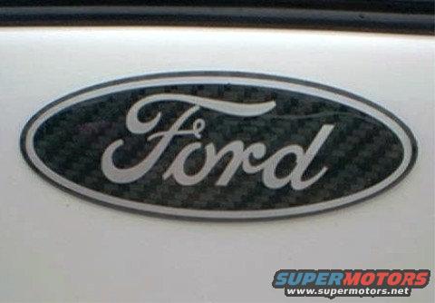 Close-up of a Ford oval emblem with a carbon fiber pattern inside