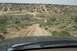 1995 Ford Bronco - View from inside a vehicle driving on an offroad trail in a desert landscape.