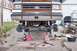 1989 Ford Bronco - Front axle of a 1989 Ford Bronco, lifted on jack stands for service, with a 4x4 badge on the grille.