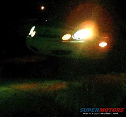 1997 Ford Taurus front with headlights on at night