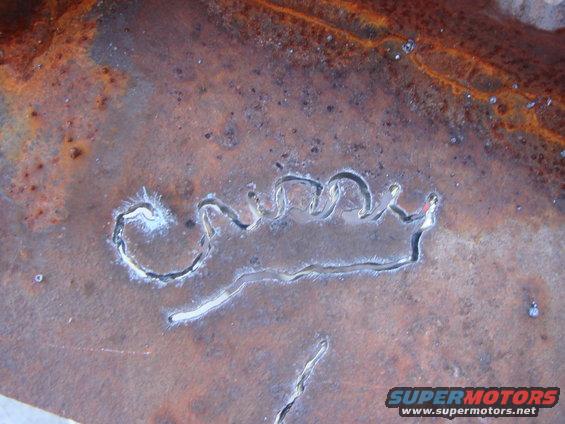 Cutout crown emblem on rusty metal