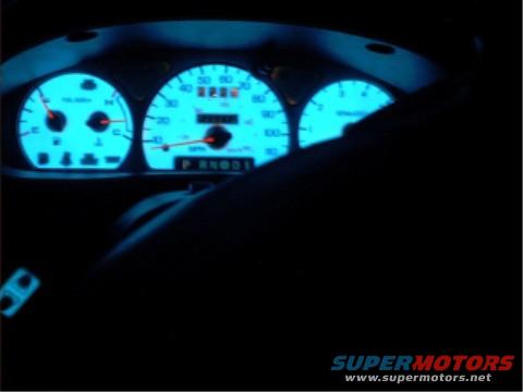 1997 Ford Taurus dashboard with glowing blue gauges and odometer reading 2285
