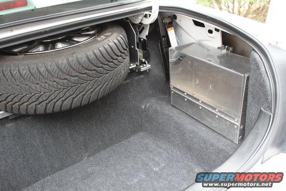 Trunk interior with spare tire and metal storage box