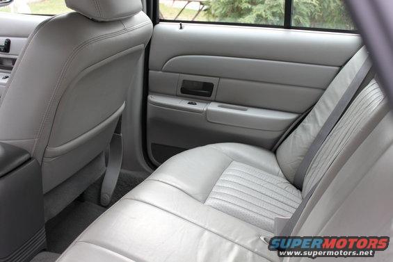 Gray leather rear seats and door panel of a 2003 Ford Crown Victoria