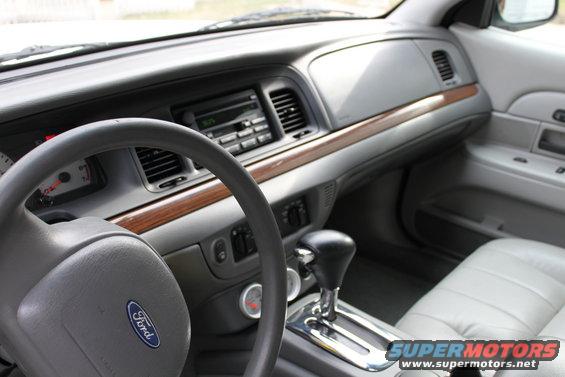Interior of a 2003 Ford Crown Victoria showing dashboard, steering wheel, and gear shifter