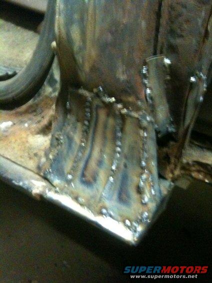 Welded metal frame with visible rust and discoloration, close-up