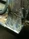 1993 Ford Bronco - Close-up view of a heavily welded and rusted metal frame section.