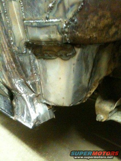 Welded metal repair on vehicle frame, close-up view