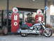 2006 Victory Kingpin - A silver motorcycle is parked next to vintage Texaco gas pumps, with an old truck visible behind them.