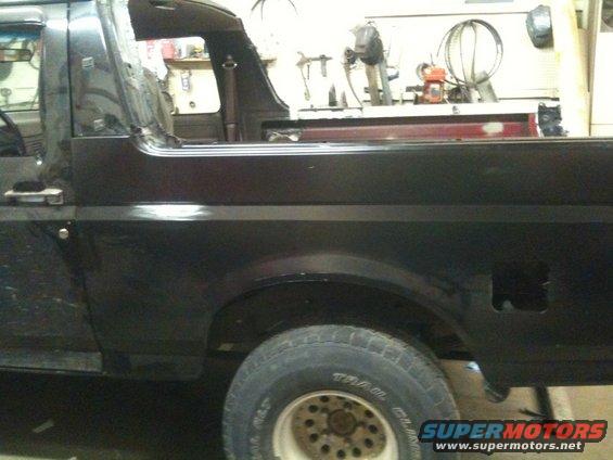 1993 Ford Bronco rear quarter panel and wheel well, showing some body damage