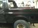 1993 Ford Bronco - Side view of a 1993 Ford Bronco, focusing on the rear quarter panel and wheel.