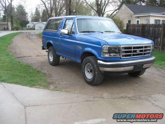 Blue 1992 Ford Bronco parked on a dirt driveway