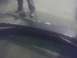 2000 Dodge 1500 - A person stands over the bed of a dark-colored truck, with reflections on the surface.