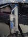 1984 Ford Bronco II - Close-up of a Fox shock absorber, likely part of an off-road suspension system.
