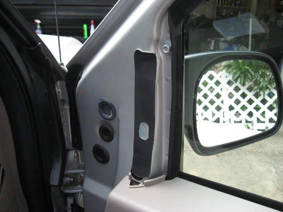 Close-up of a truck's interior door frame, showing the mirror and some trim pieces