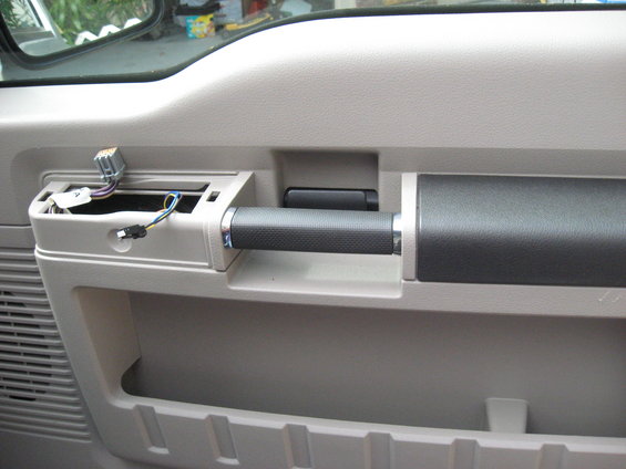 2008 Ford F-250 interior door panel with exposed wiring and grab handle