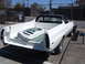 1973 Ford Ranchero - A white Ford Ranchero pickup truck sits in a lot, its bed empty except for a metal panel.