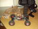1992 Ford Ranger - RC rock crawler parts laid out on a table, including a clear body, tires, and remote control.