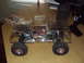 1992 Ford Ranger - RC truck with clear body and visible internal components, next to its remote control transmitter.