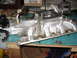 1981 Ford Mustang - This is an engine intake manifold, likely for a V8 engine, sitting on a workbench.