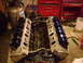 1981 Ford Mustang - V8 engine block with valve covers removed, showing internal components. Garage setting.