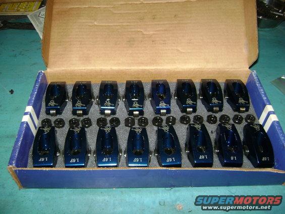 Box of 16 blue roller rocker arms with '1.6F' marking and a logo