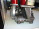 1993 Ford Taurus - A turbocharger component is shown in detail, resting on a flat surface with some background items.