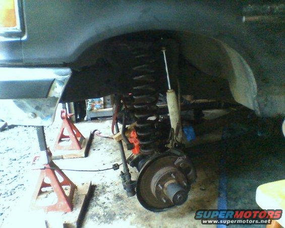 Front suspension and brake assembly of a 1987 Ford Bronco on jack stands