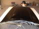 1973 Ford Ranchero - A car hood is prepared for painting in a workshop setting.
