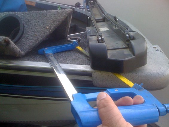 Blue trolling motor handle and part of boat interior