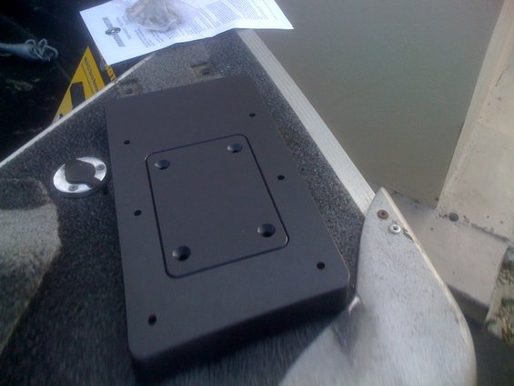 Trolling motor mount on a boat deck with instructions nearby