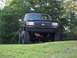 1990 Ford Bronco - This lifted Ford truck features a prominent grille and 4x4 badging, suggesting a model year in the late 1980s.